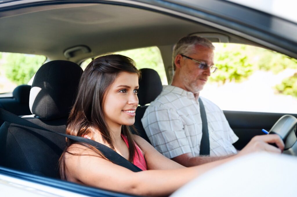teenager learning to drive with instructor