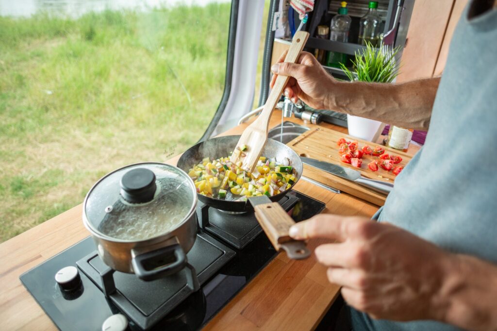 Cooking food in van conversion on stovetop